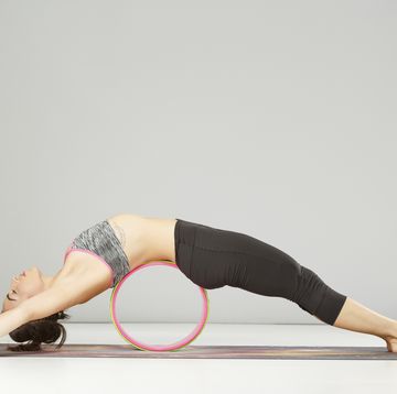 pilates stretching  training  yoga wheel poses woman practicing advanced yoga