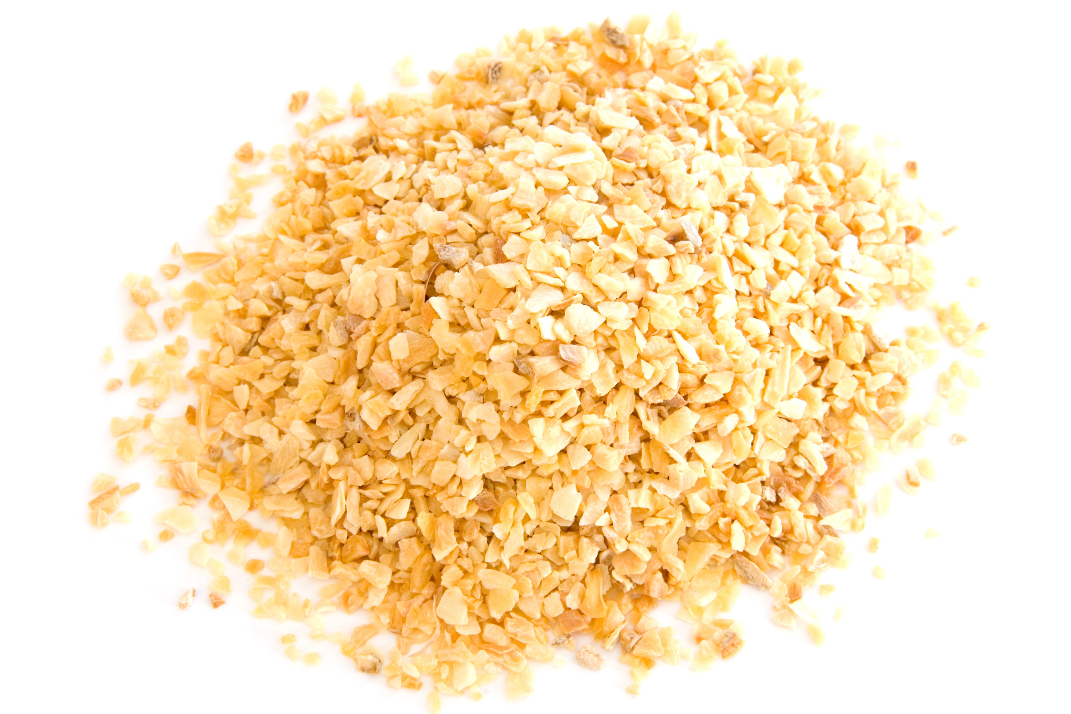 Pile of dehydrated onion flakes on white