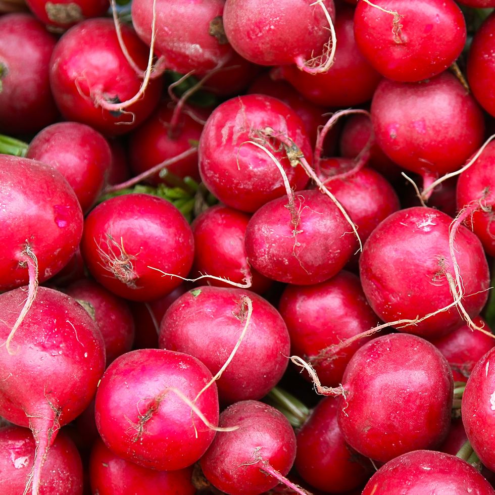 pile of radishes being sold on market