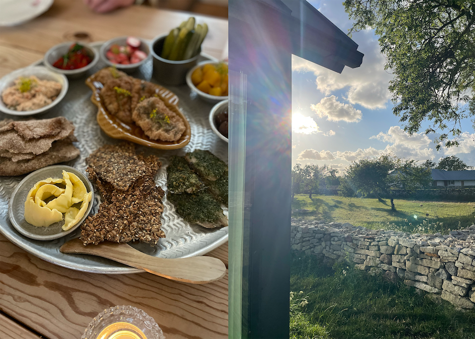 a spread of food on a wooden table beside a scenic view