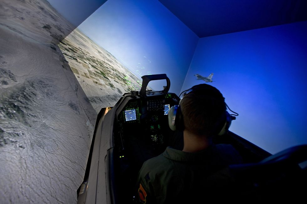 a pilot from the 56th fighter wing in luke air force base, arizona, flies the f 16 simulator