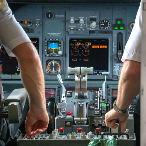 Pilots reset controls in the cabin of a Boeing 737 (600 or...