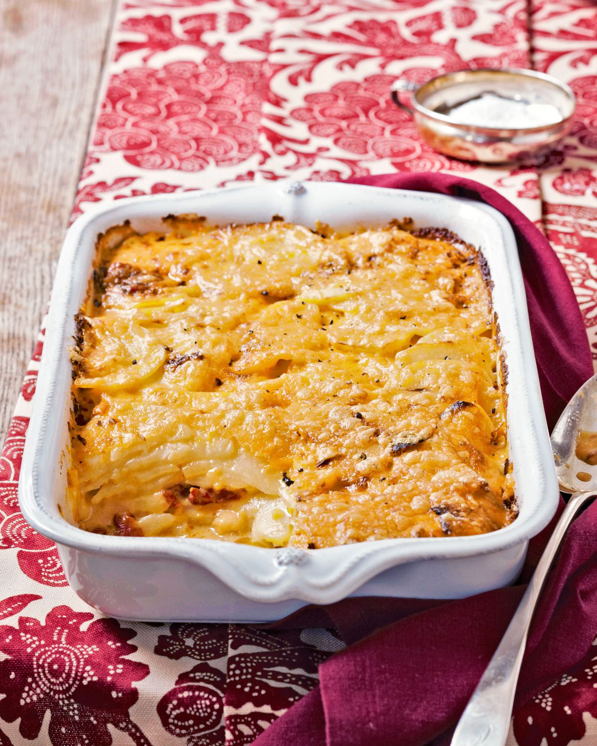 pimento cheese potato gratin in a serving dish on a nice tablecloth