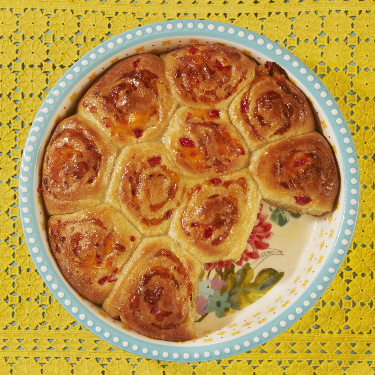 pimiento cheese buns in baking dish with yellow lace fabric