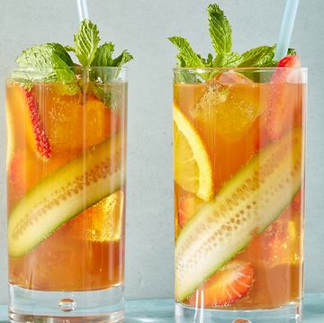 pimm's cup cocktail with cucumber, strawberries, and orange slices with fresh mint