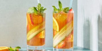 pimm's cup cocktail with cucumber, strawberries, and orange slices with fresh mint