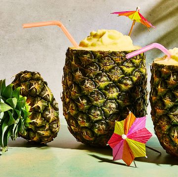 pineapple pina coladas in a pineapple with umbrellas
