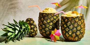 pineapple pina coladas in a pineapple with umbrellas