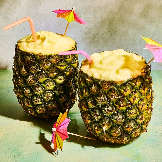 pineapple pina coladas in a pineapple with umbrellas