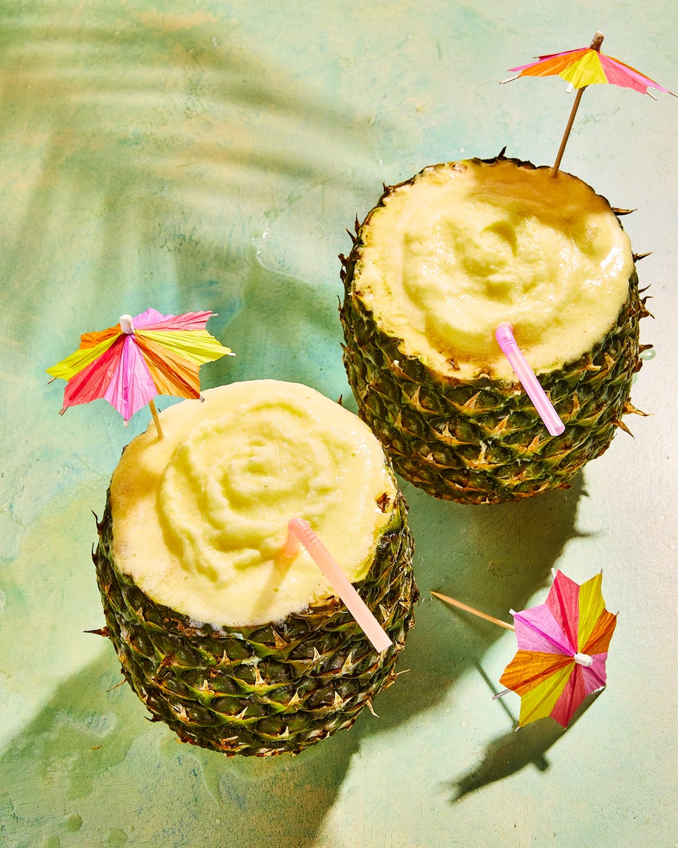 pineapple pina coladas in a pineapple with umbrellas