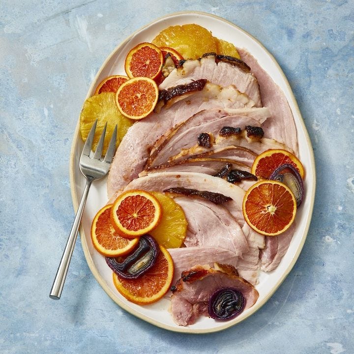 pineplle glazed ham with slices of orange on top