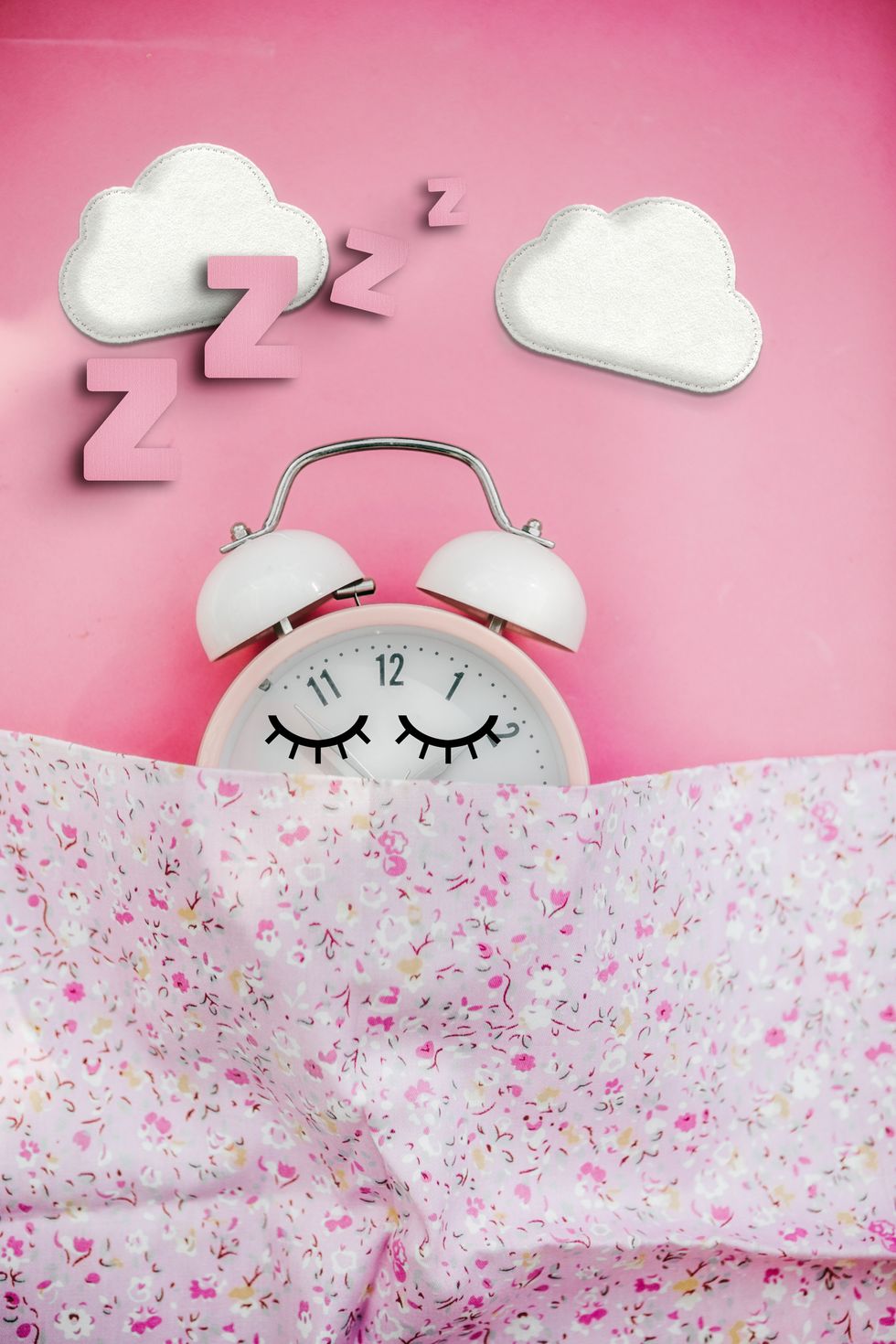 pink alarm clock  sleeping in bed