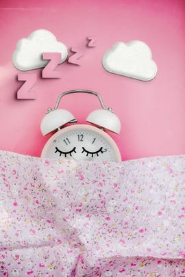 pink alarm clock sleeping in bed