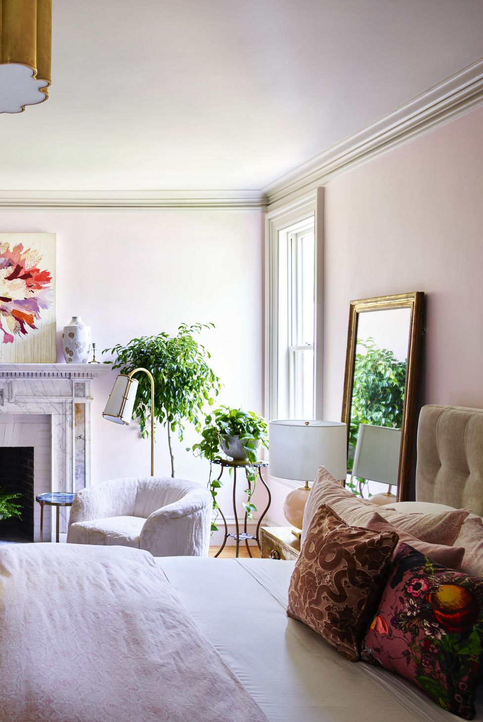 primary bedroom
casagrande salvaged this
marble mantel from a home in a
neighboring town built in the same
period wall paint middleton
pink, farrow  ball ceiling light
alexa hampton for circa lighting
art christopher
peter above
fireplace jordan piantedosi
dresser and rug chairish