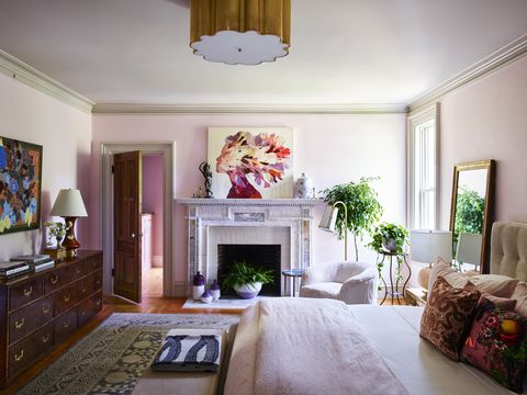 primary bedroom
casagrande salvaged this
marble mantel from a home in a
neighboring town built in the same
period wall paint middleton
pink, farrow  ball ceiling light
alexa hampton for circa lighting
art christopher
peter above
fireplace jordan piantedosi
dresser and rug chairish
