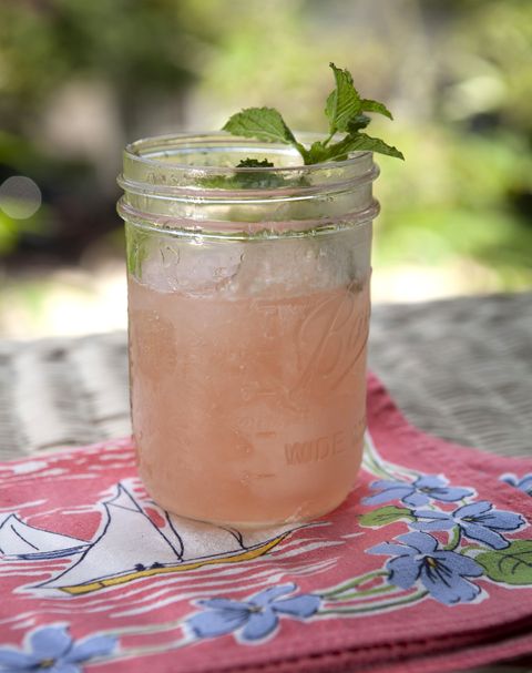 watermelon frose in a mason jar and garnished with a sprig of fresh mint