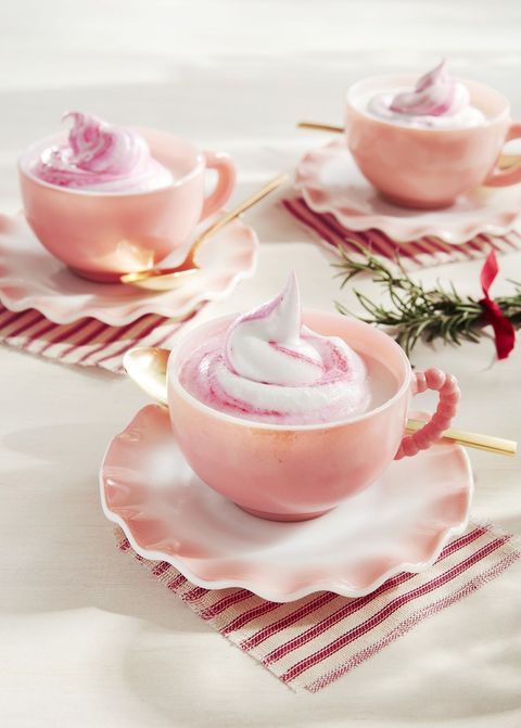 white hot chocolate in light pink mugs with pink swirled whipped cream on top