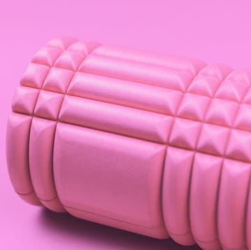 Pink foam roller on pink background. pink foam roller on pink background