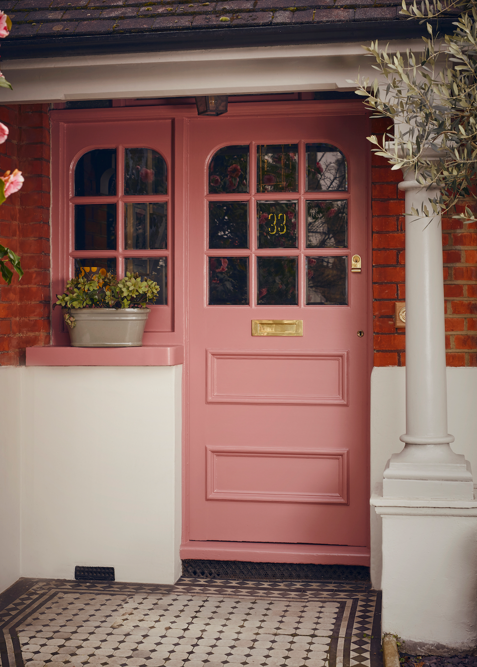 a pink door with a white pillar