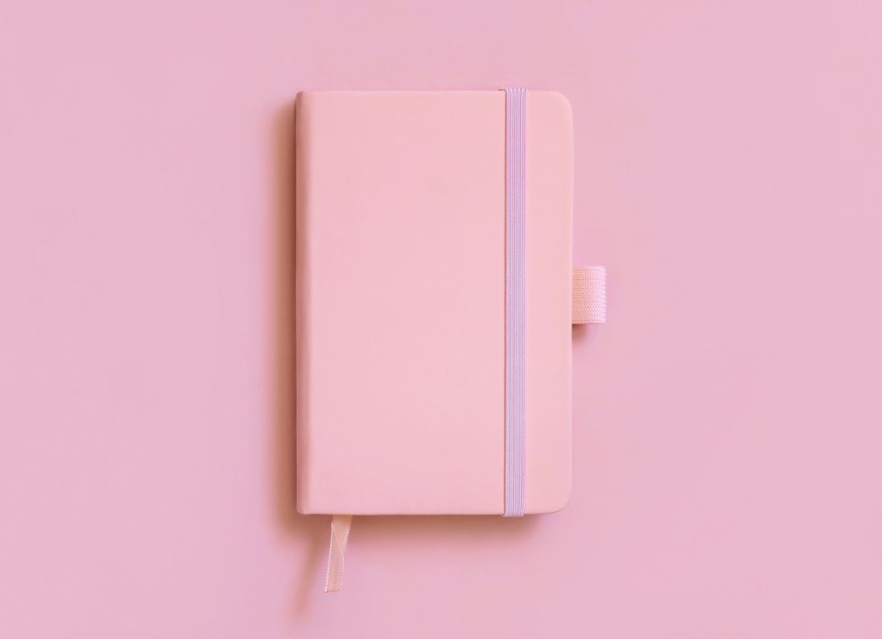 pink hardcover notebook on light pink top view textbook cover mockup
