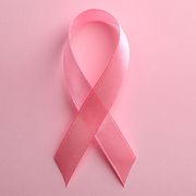pink ribbon on color background, top view with space for text breast cancer awareness concept