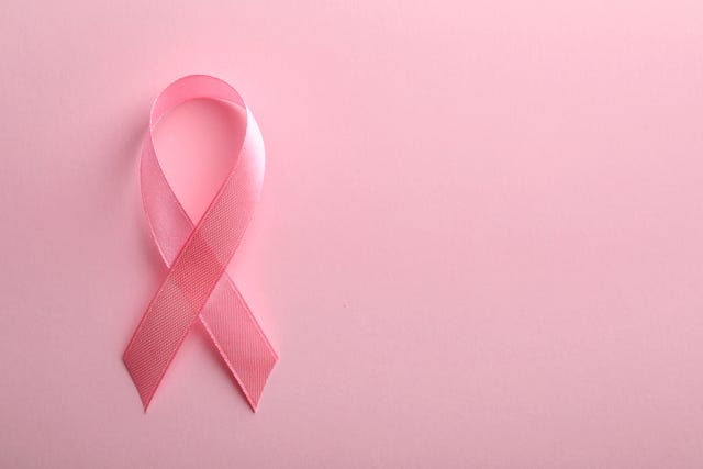 pink ribbon on color background, top view with space for text breast cancer awareness concept