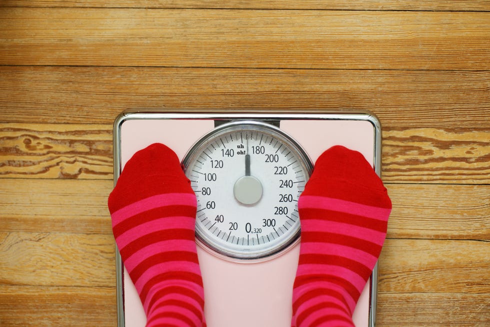 Pink striped socks standing on pink scale