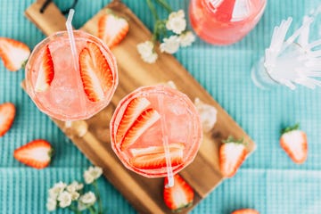 pink summer cocktail drink from above with strawberries