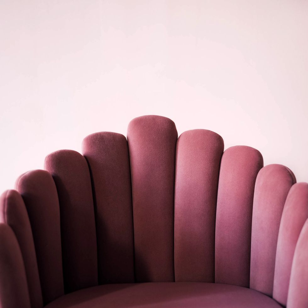 pink textured velor armchair on a pink background