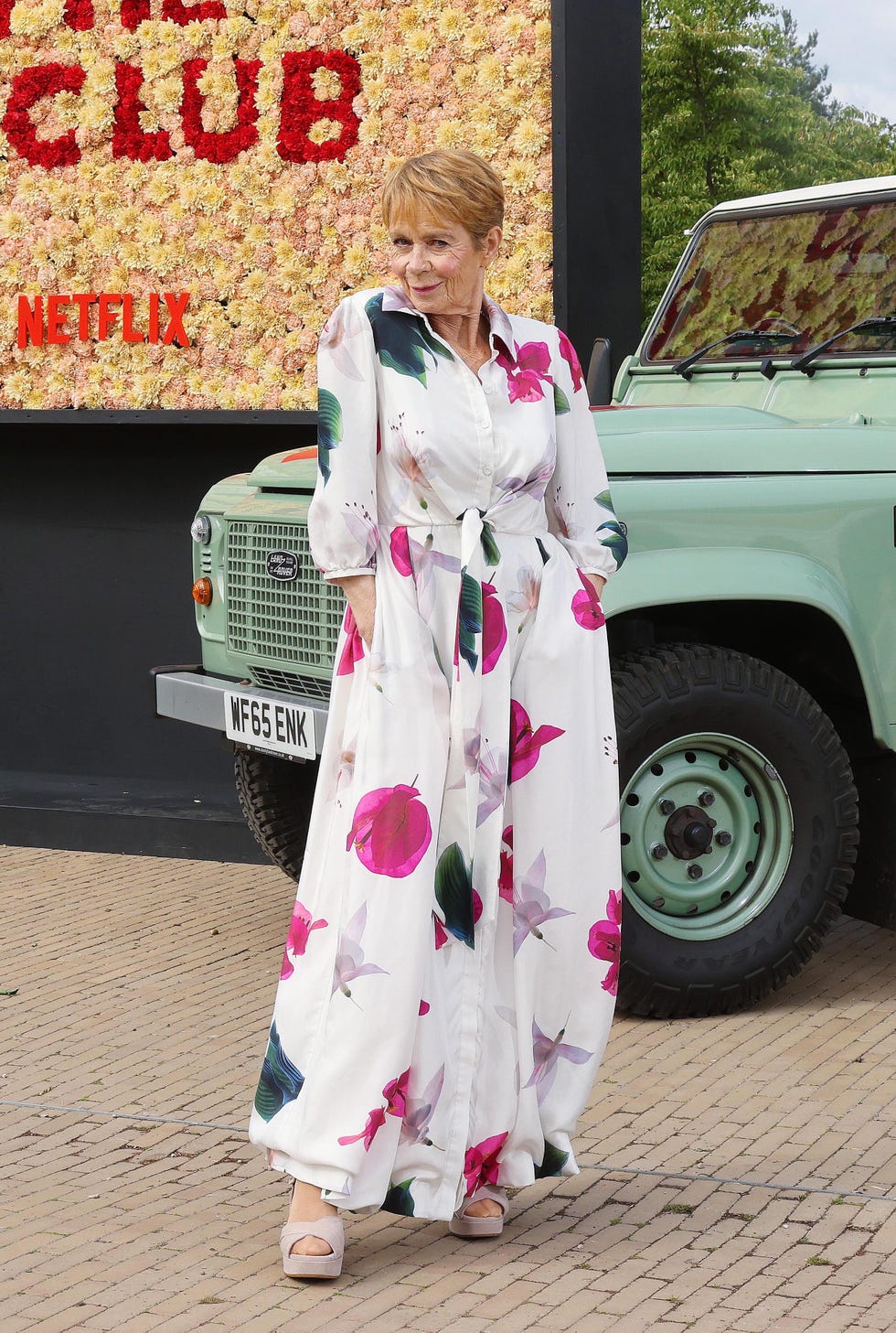 *** free for editorial use ***actress celia imrie unveils unveils netflix’ the thursday murder club: unearth the plot immersive experience at rhs garden wisley. visitors nationwide will enjoy a week of murderously good fun, with themed floral billboards, murder mystery trails and ‘joyce’s tearoom’ at wisley. picture date: thursday august 22, 2025. pinpep