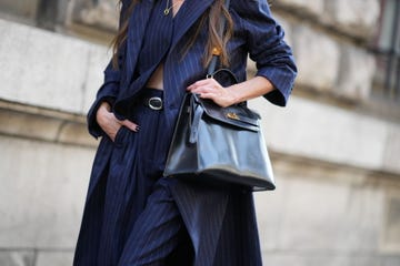paris, france september 30 a guest wears a blue striped outfit and a black leather hermes bag, outside hermes, during the womenswear springsummer 2024 as part of paris fashion week on september 30, 2023 in paris, france photo by edward berthelotgetty images