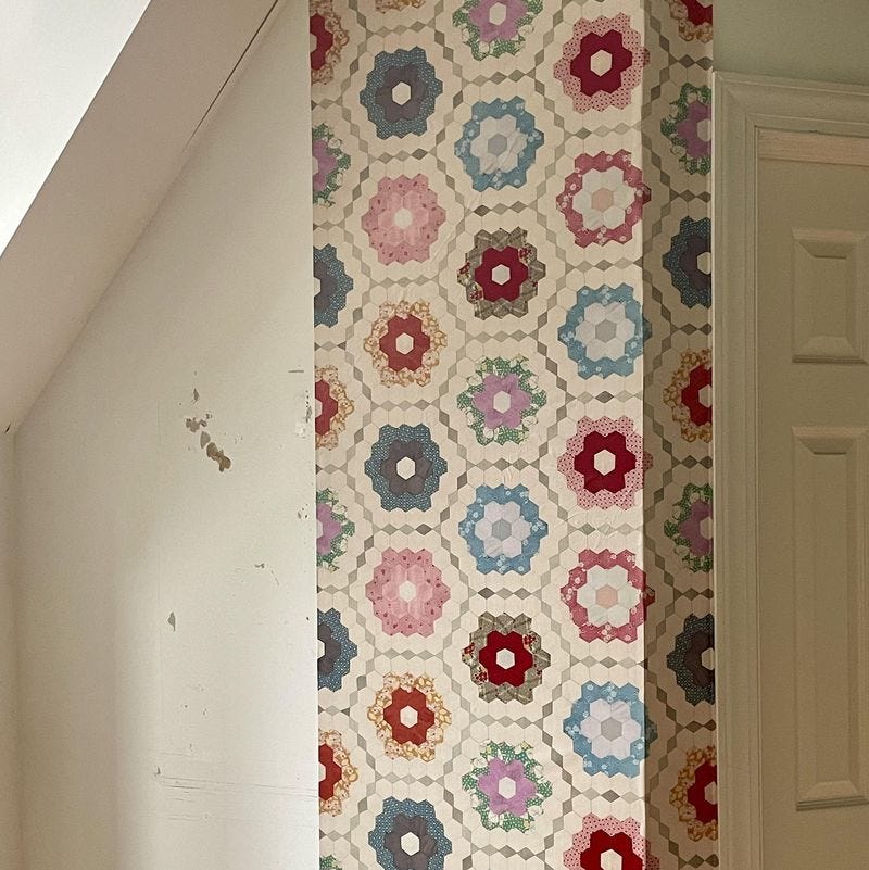 a wall with quilt patterned wallpaper