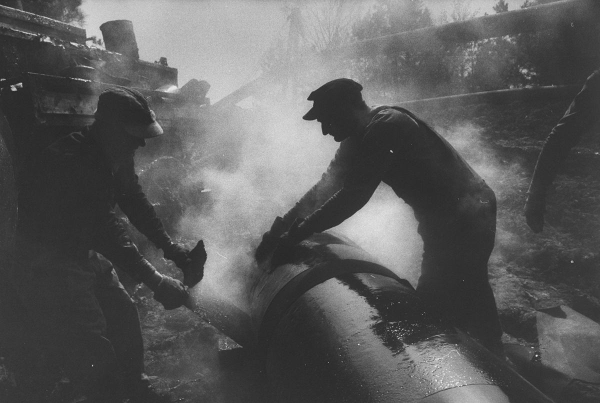 men laying pipeline  photo by grey villetthe life picture collection via getty images