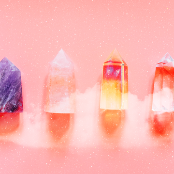 crystals of various colors lie next to each other on a pink background