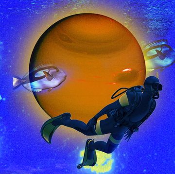 a scuba diver swimming next to a planet