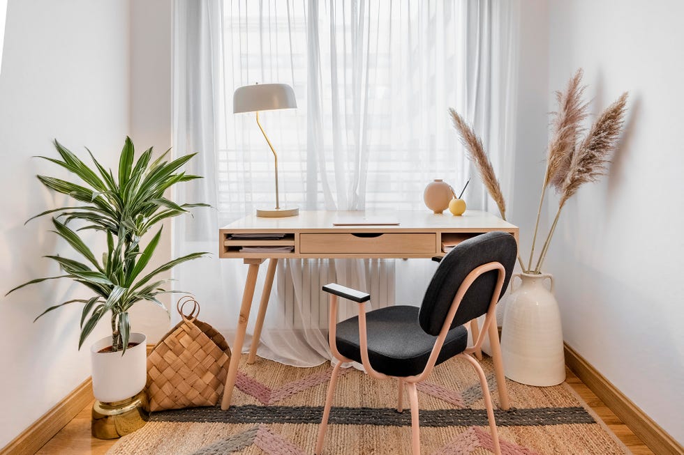 Despacho con escritorio de madera decorado con plantas