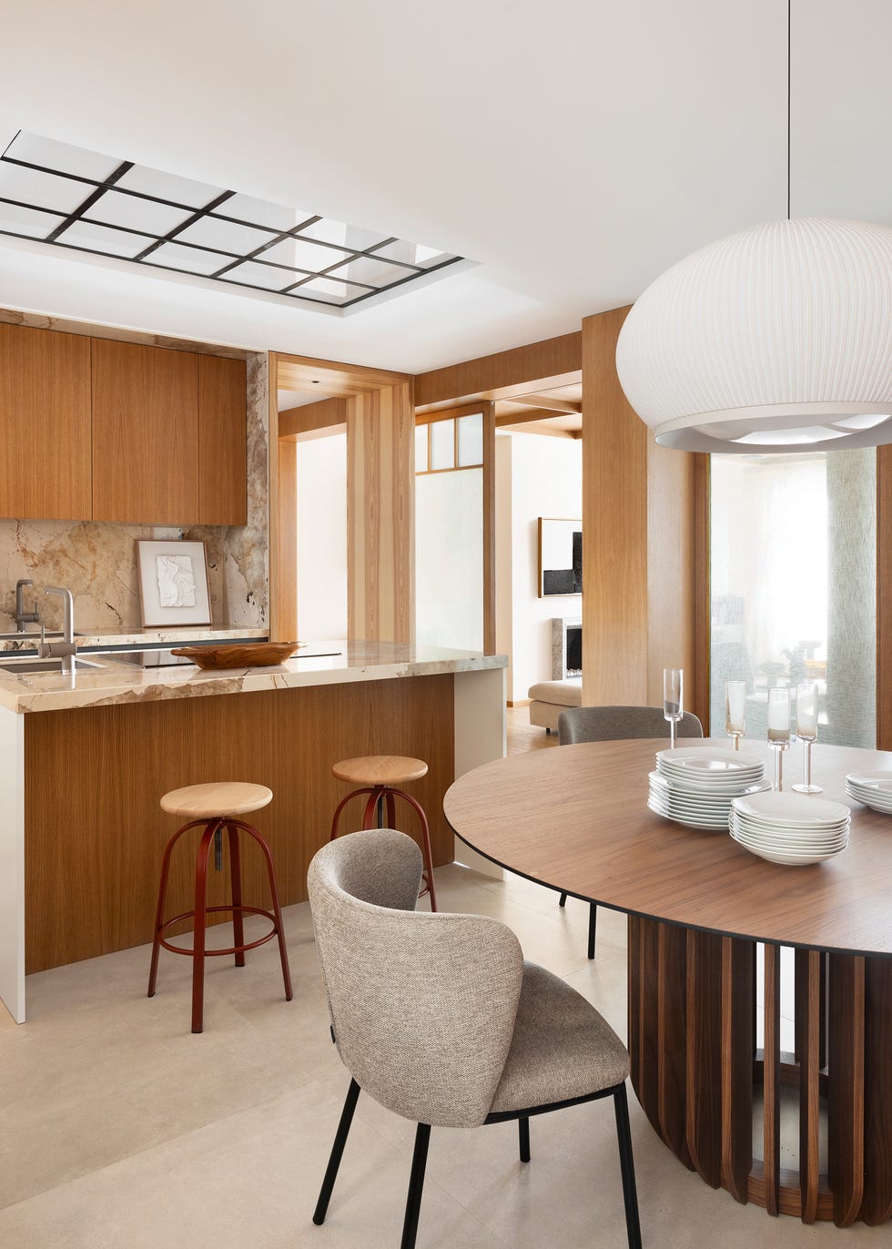 cocina con isla central y mesa de comedor de madera redonda