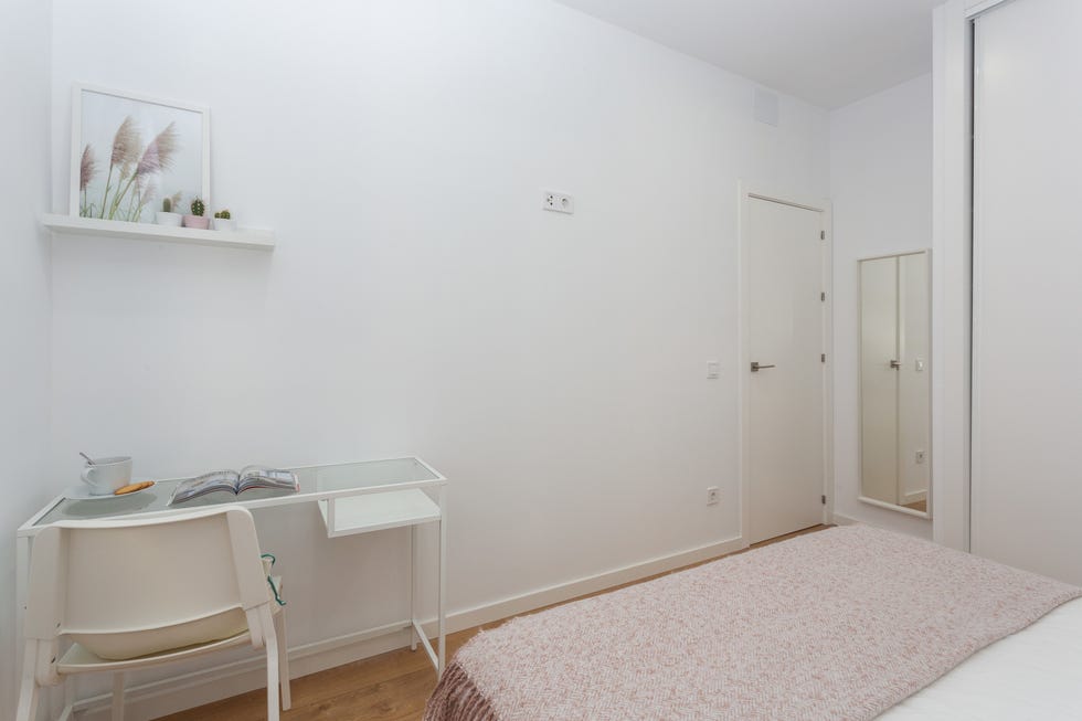 escritorio blanco de metal y cristal en el dormitorio