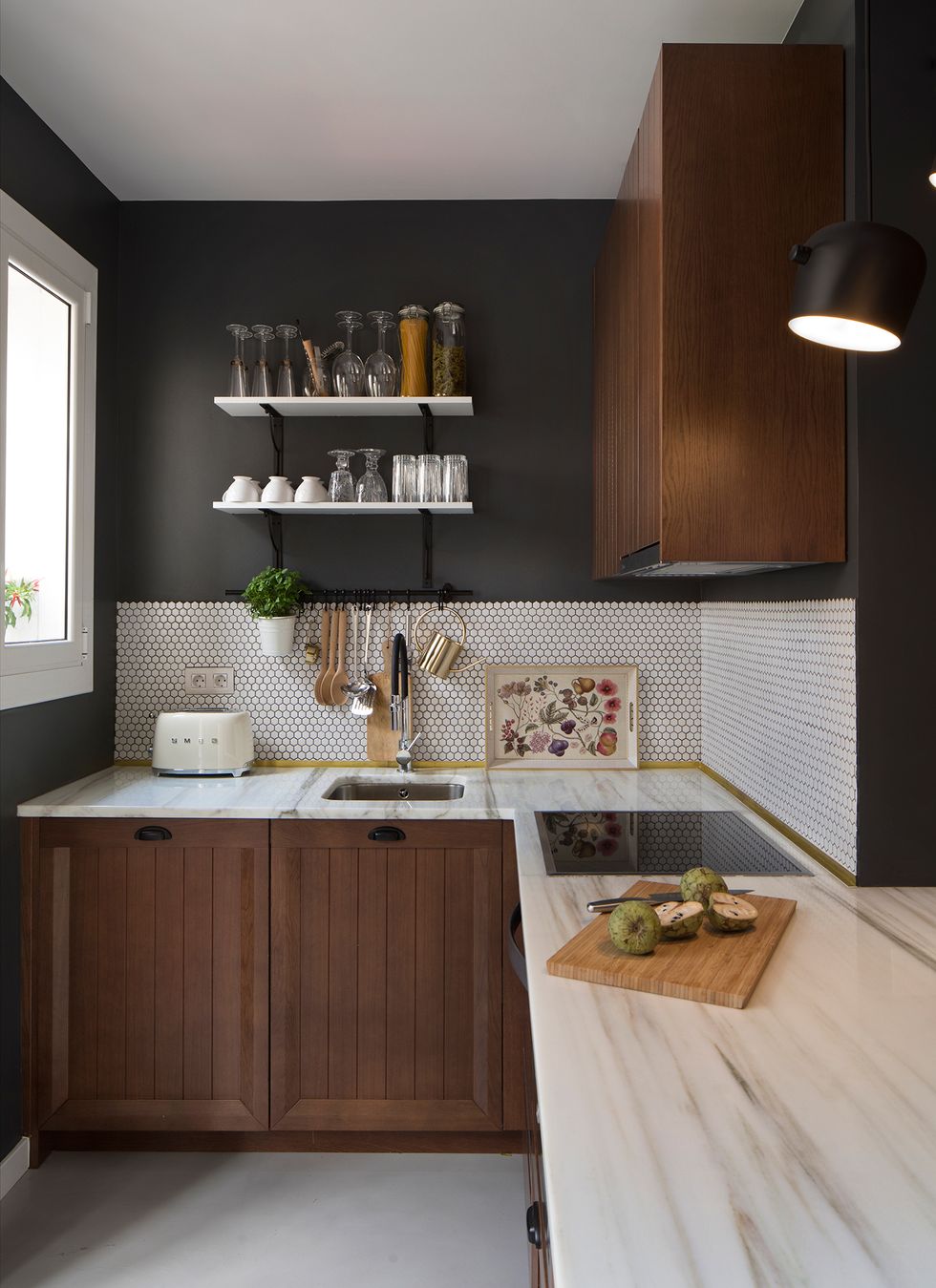 Cocina con encimera de mármol, armarios de madera y frente de azulejos hexagonales en color blanco