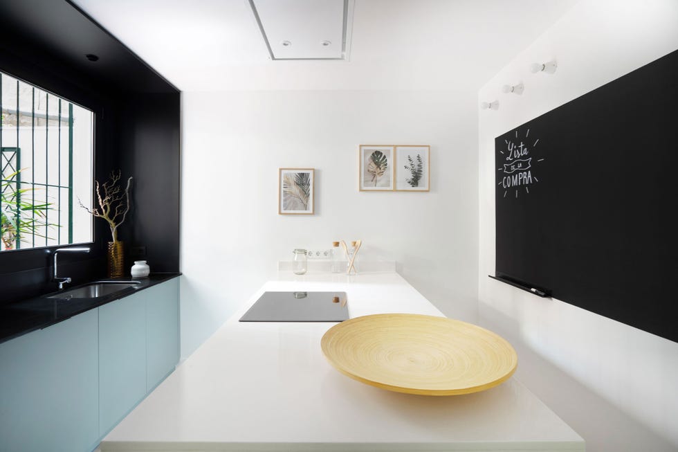 cocina blanca moderna con isla y cerramiento de vidrio