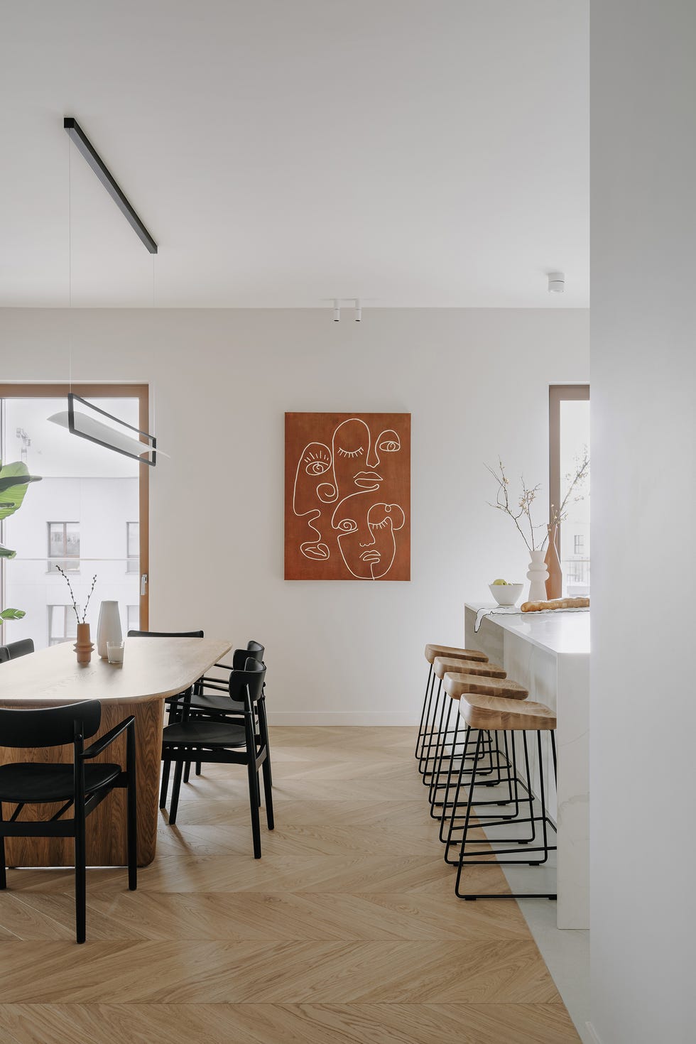 mesa de comedor de madera con sillas negras junto a la isla