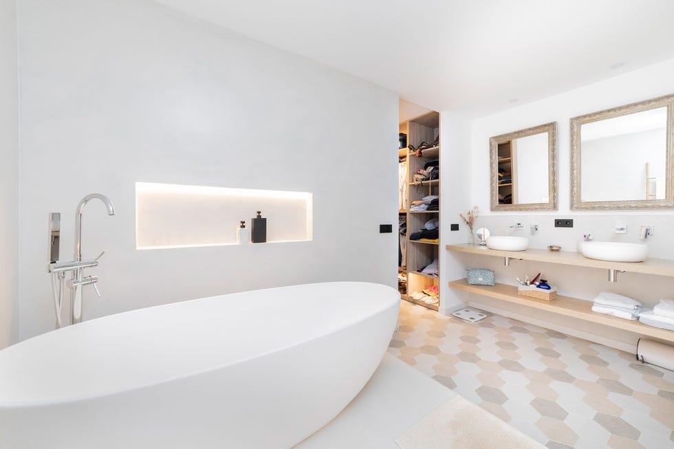 bañera exenta blanca junto al vestidor
