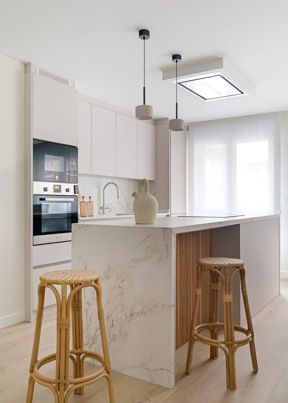cocina con isla de mármol y palillería de madera