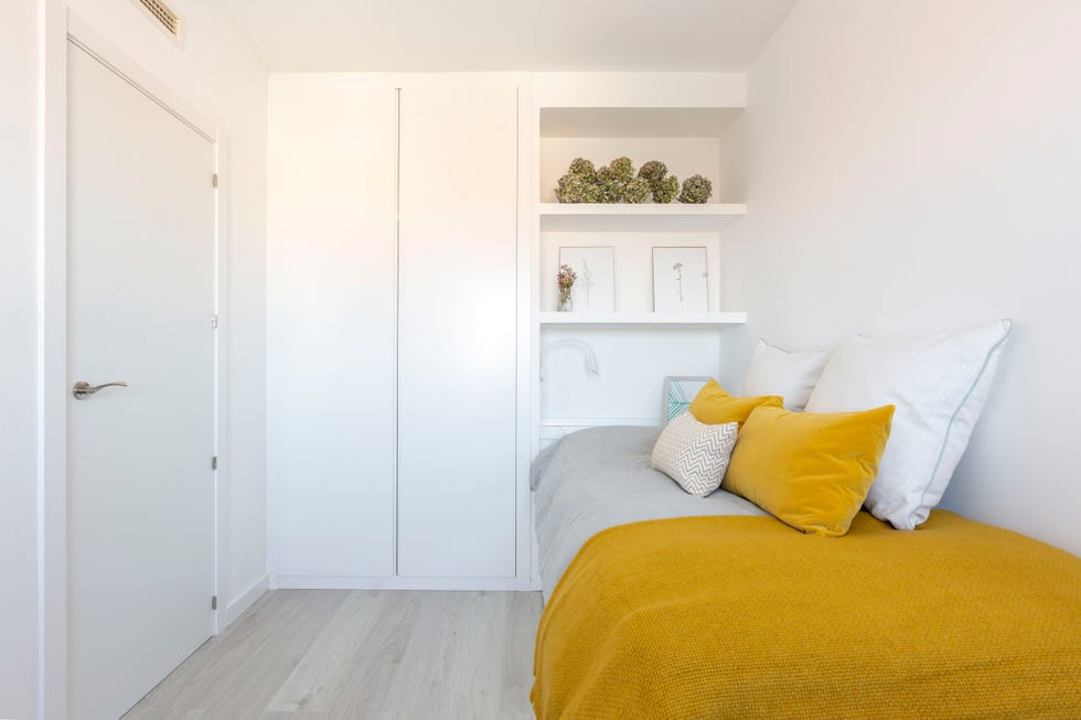 dormitorio juvenil con cama nido decorado en blanco con ropa de cama mostaza