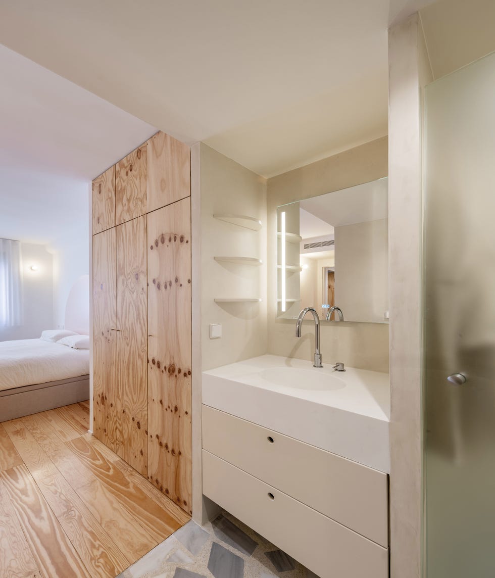 dormitorio con armarios de madera de pino y baño en suite