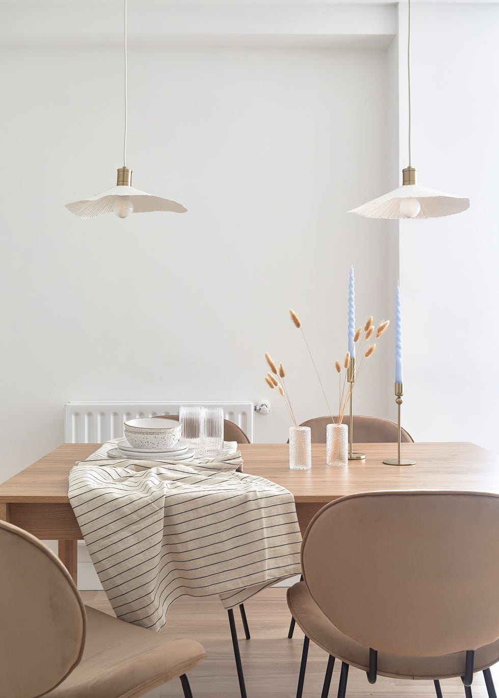 mesa de comedor de madera moderna y sillas de terciopelo en color tierra