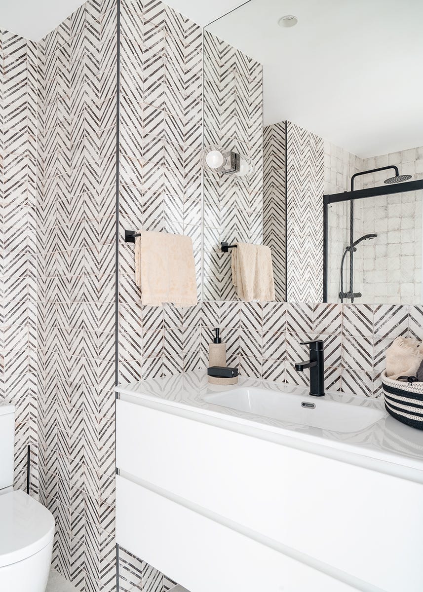 baño moderno con mueble suspendido y azulejos geométricos