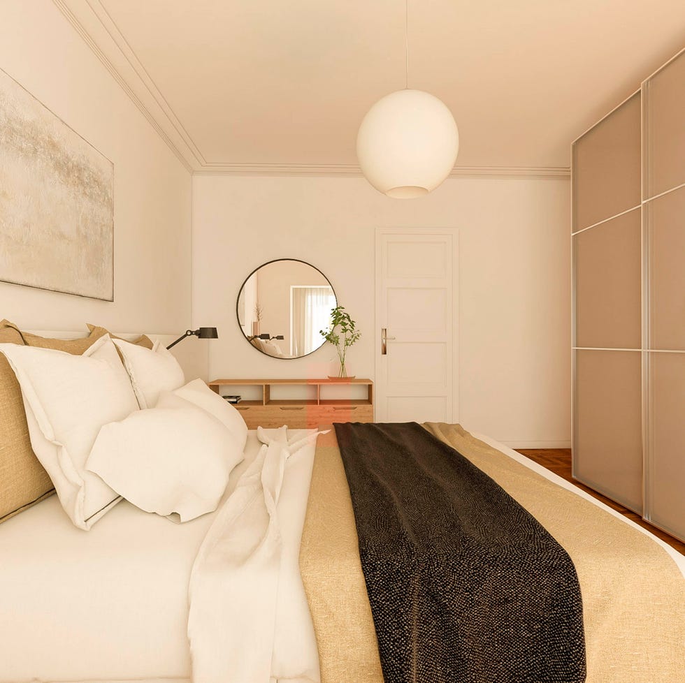 dormitorio con cómoda de madera y espejo redondo