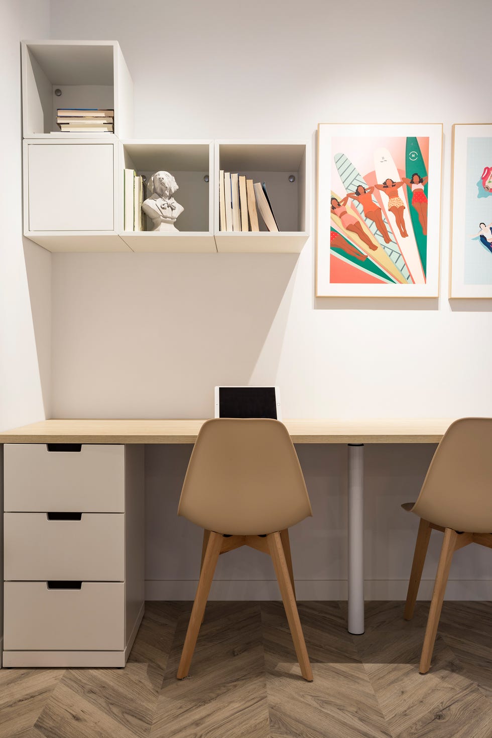 escritorio minimalista con dos sillas, cajonera y tablero de madera