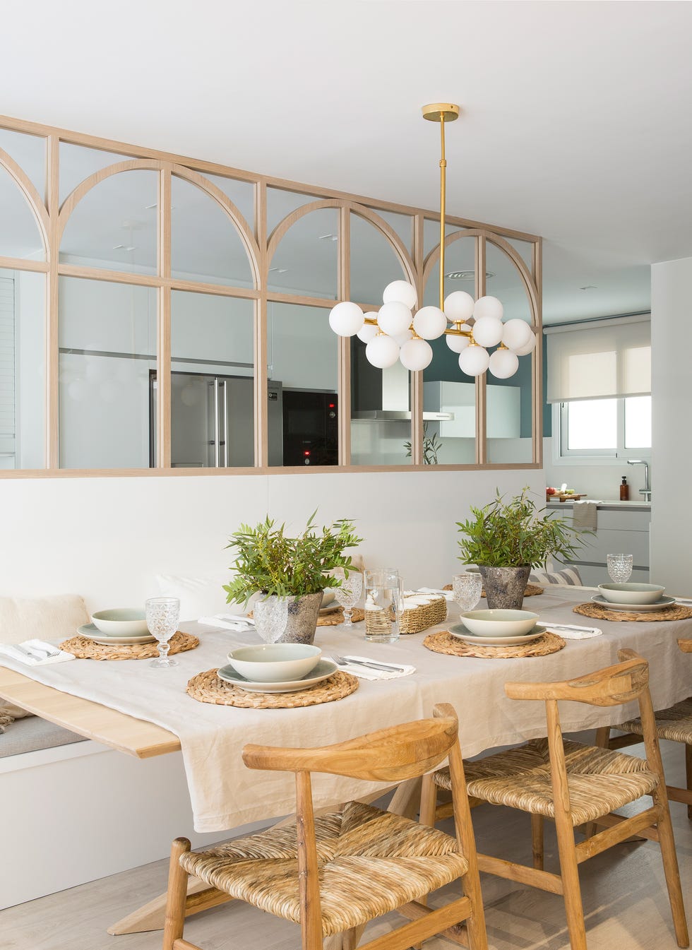 comedor con banco de obra, sillas de madera y biombo que lo separa de la cocina